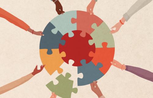 diverse hands putting together a puzzle piece
